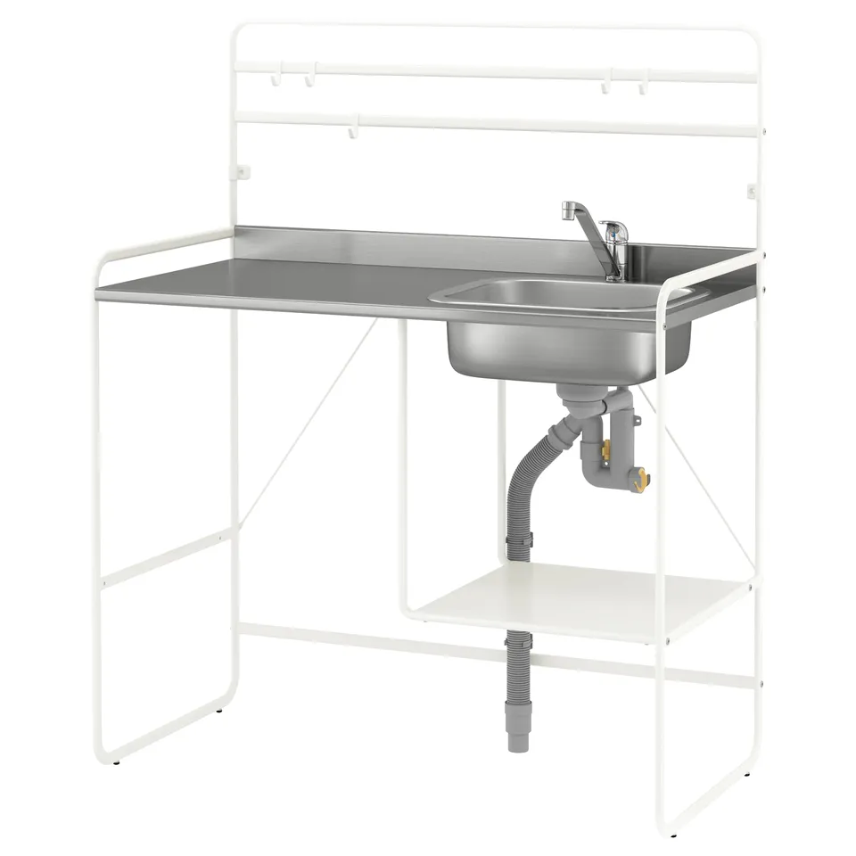 A white SUNNERSTA mini-kitchen with a stainless steel sink, featuring adjustable feet and a reversible shelf, ideal for small spaces.