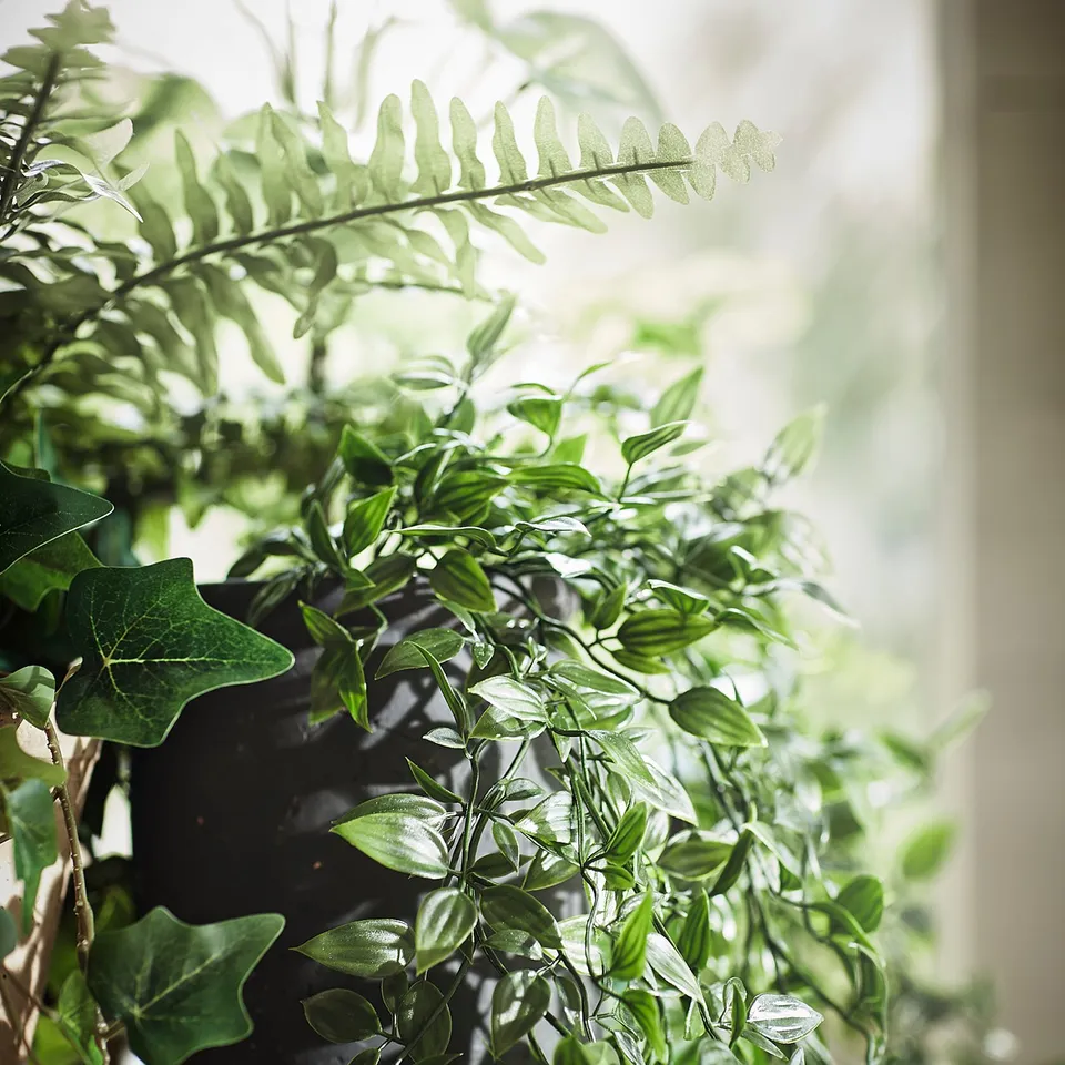 Green potted artificial plants on wooden shelf. Lifelike leaves, indoor/outdoor use.