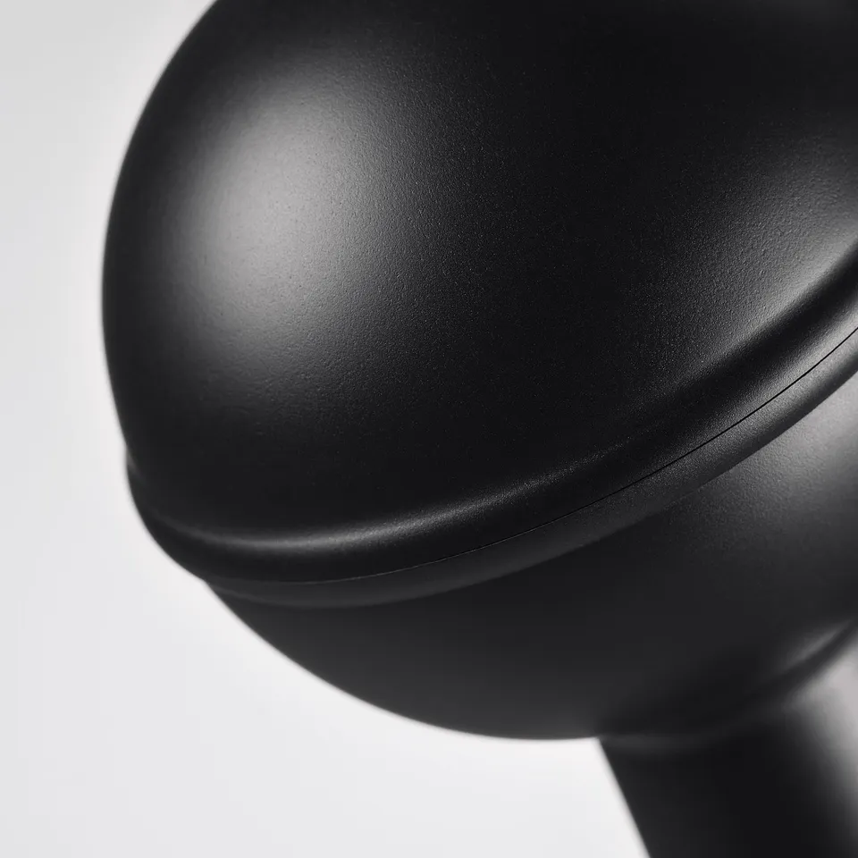Black circular plastic ceiling finial, smooth and sleek, part of the ALVARSTÅNDS collection, mounted on a rod.