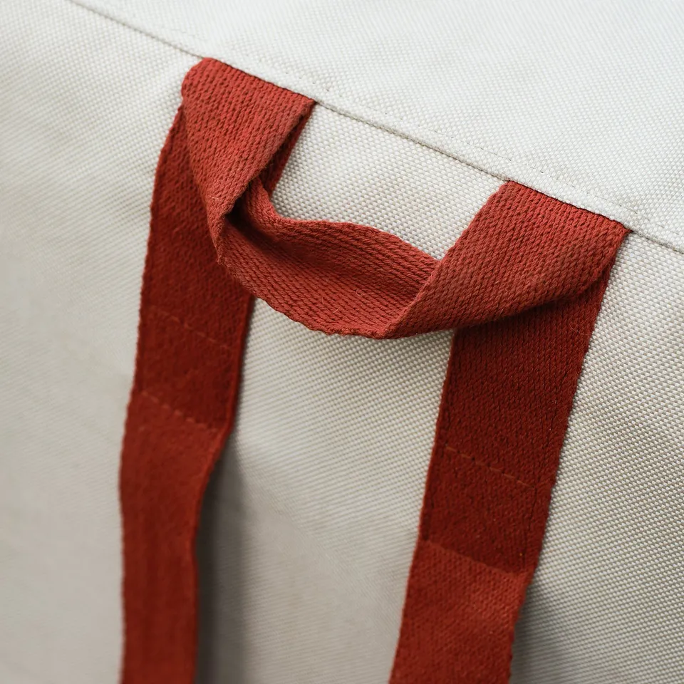 Close-up of durable, textured fabric straps on foldable mattress. Straps appear robust, sturdy, and integrated securely with the mattress.