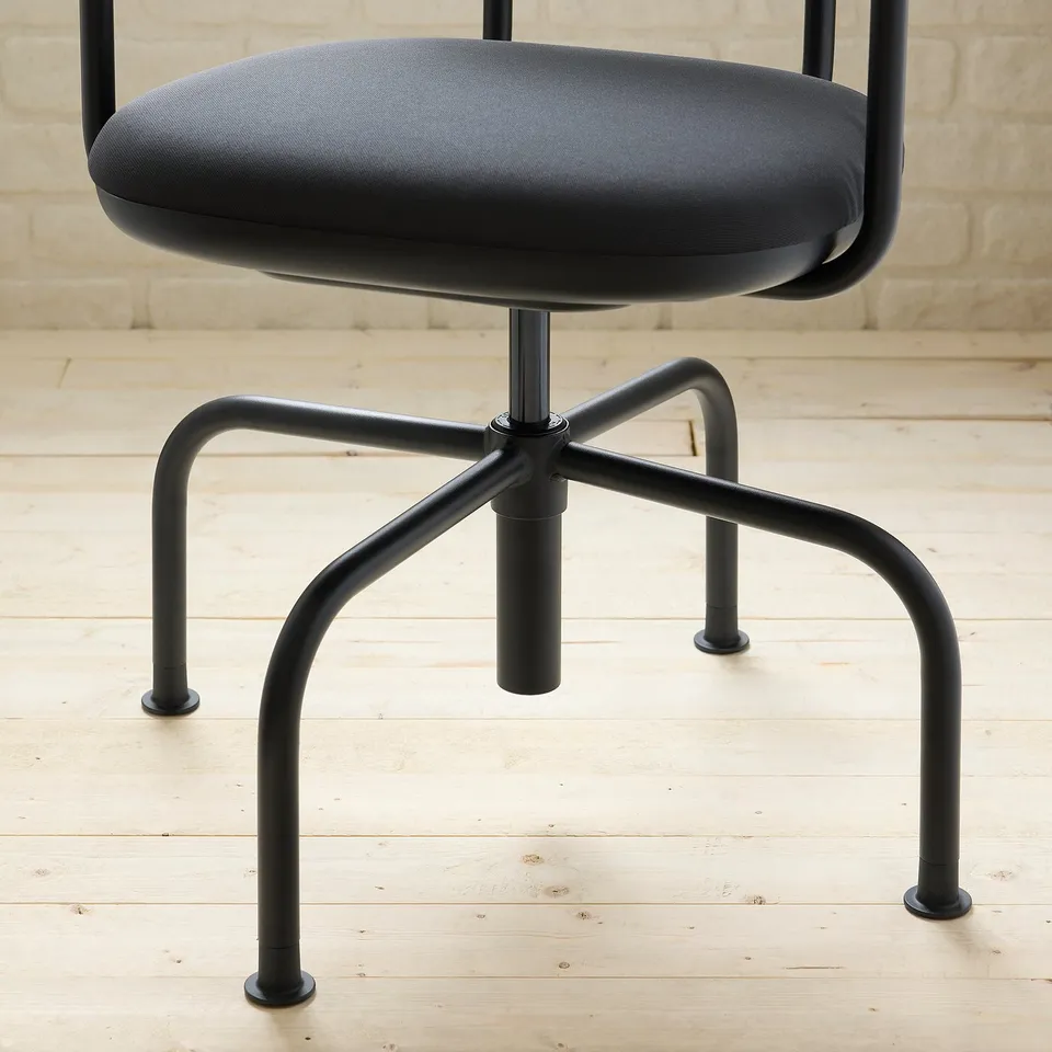 Black office stool with cushioned seat and back, sturdy metal legs, modern design.
