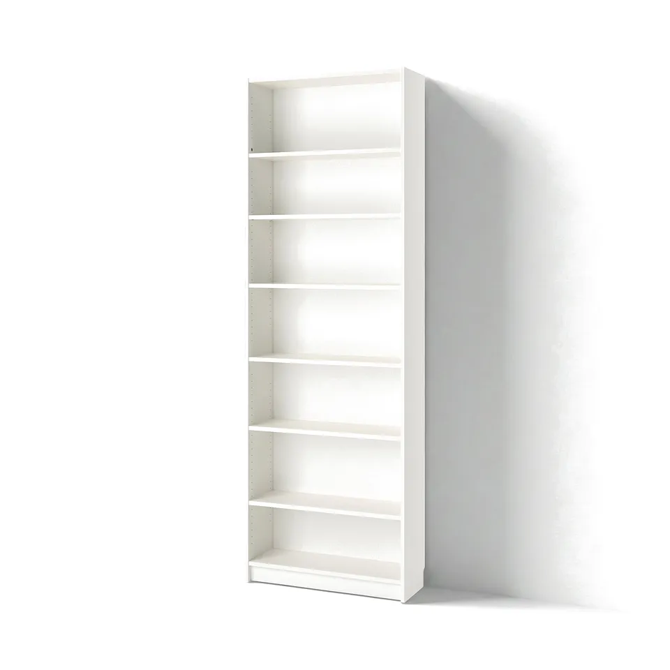 An empty white BILLY bookcase with six adjustable shelves, standing against a white wall.