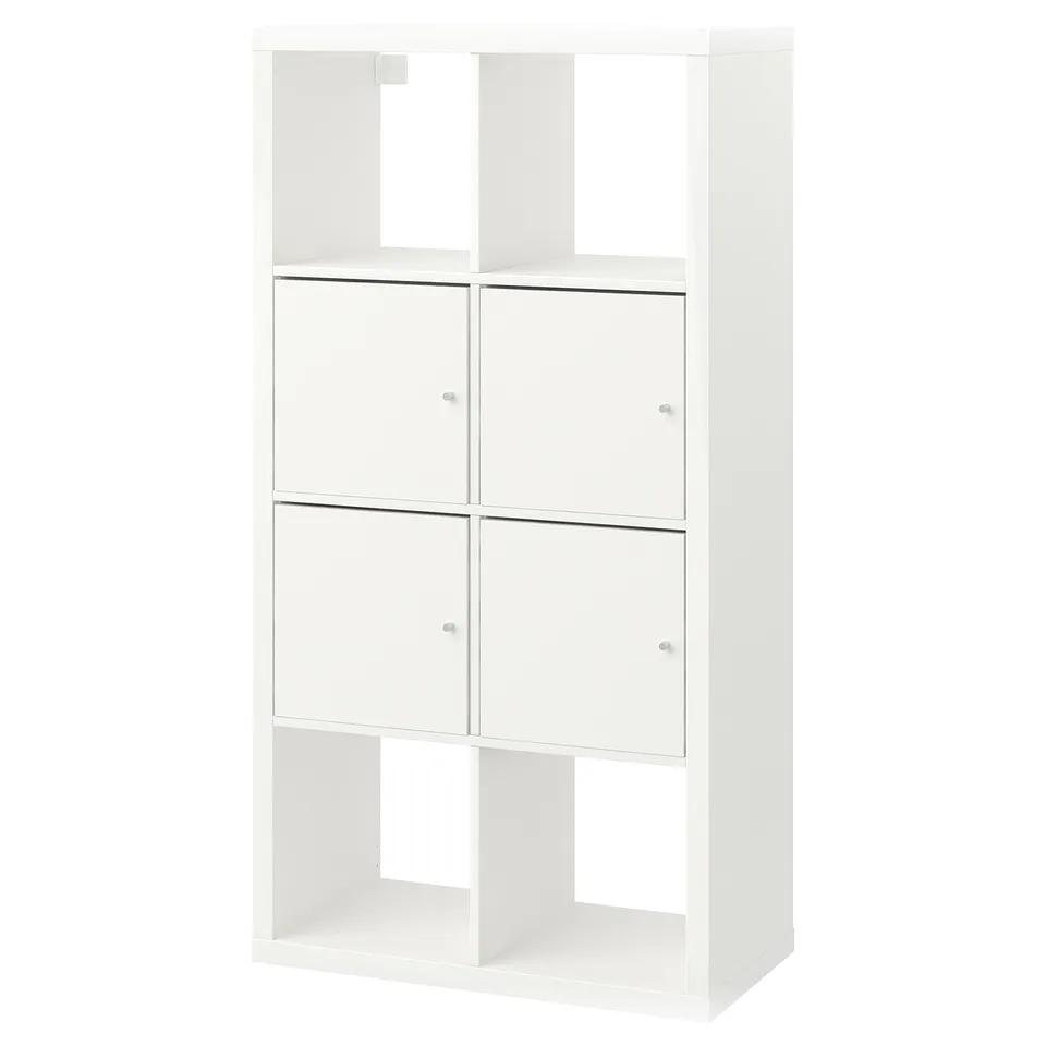 Displays a white ikea KALLAX storage unit, featuring open and closed compartments with a minimalist design, suitable for organizing items.