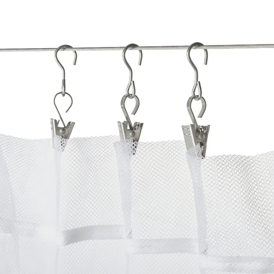 Three metallic curtain hooks with clips holding sheer white curtains, ideal for both living spaces and bathrooms.