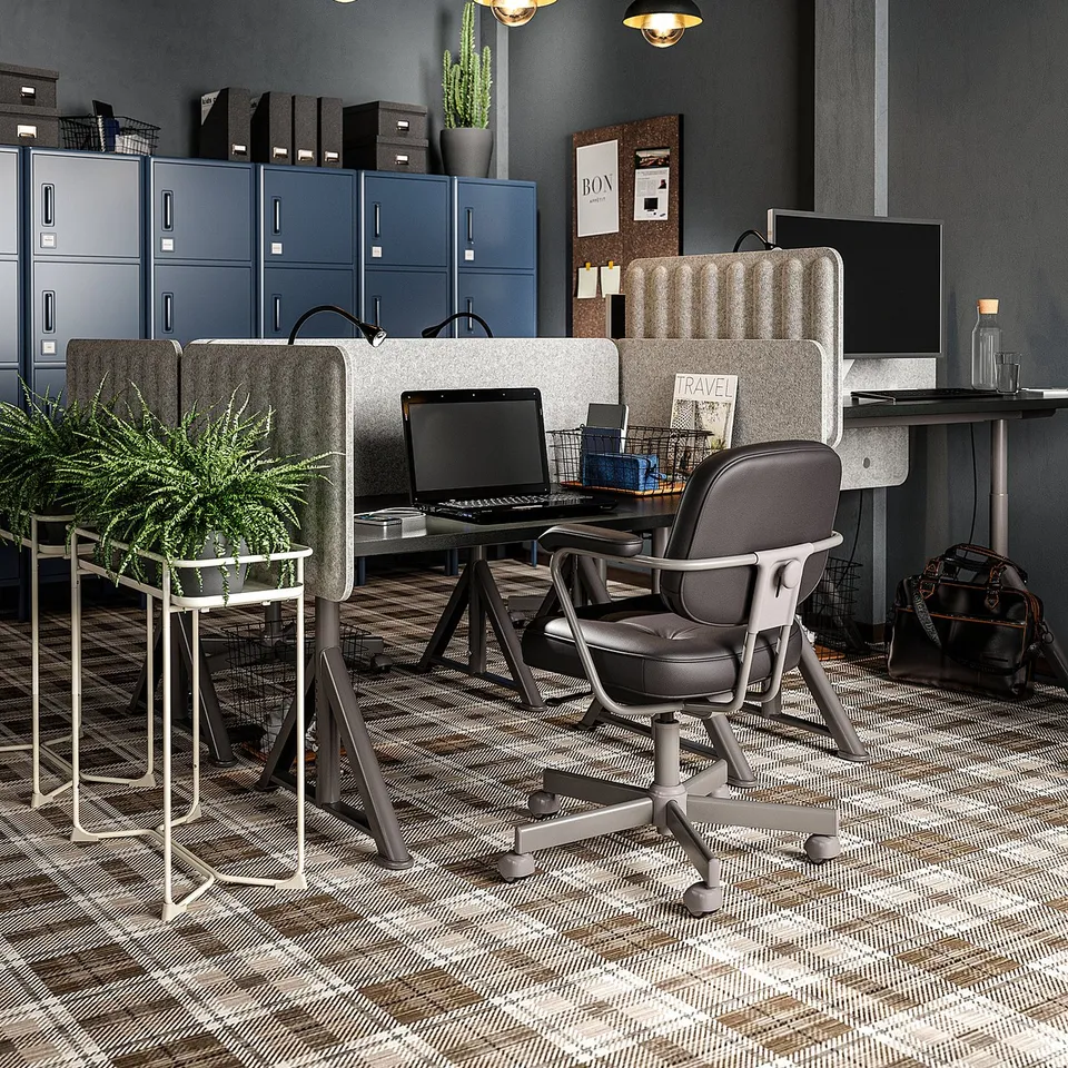 Modern office with grey furniture, black pendant lamps, and a green plant.