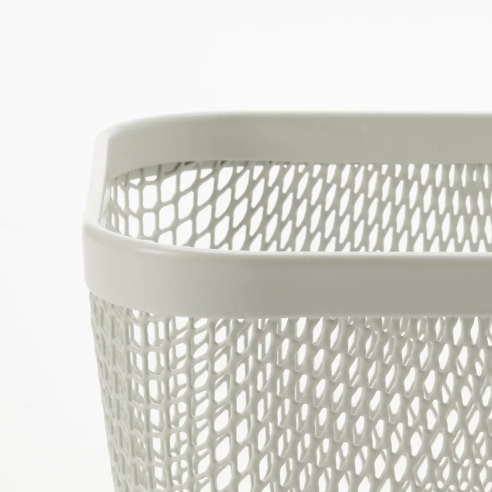 Close-up view of a white mesh storage basket, showcasing its intricate diamond-shaped openings and sturdy edges, ideal for food storage.