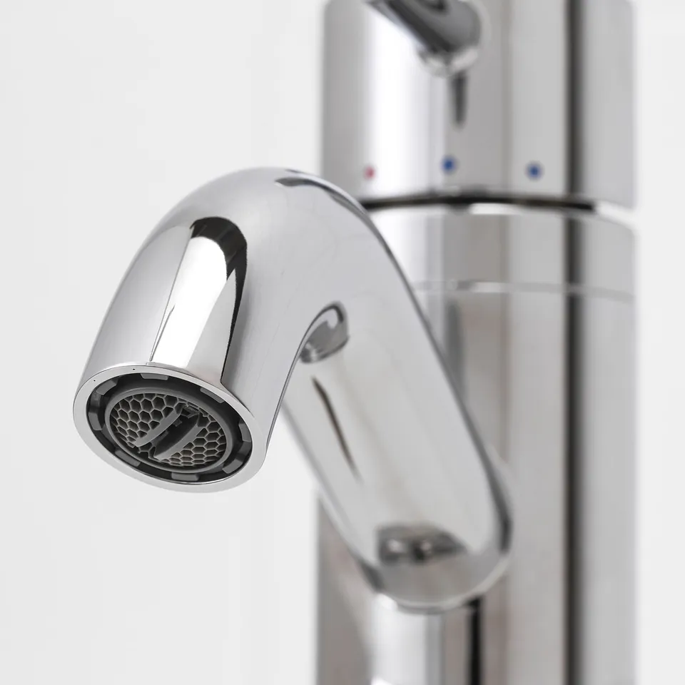 Close-up of polished chrome tap, showing intricate detailing and high-quality finish.