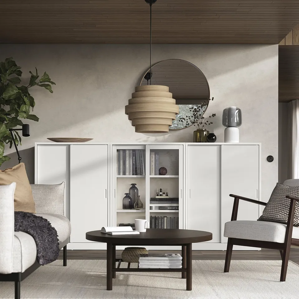 Modern living room off-white TONSTAD cabinet with sliding doors, grey furniture, and wooden coffee table under a large pendant lamp.