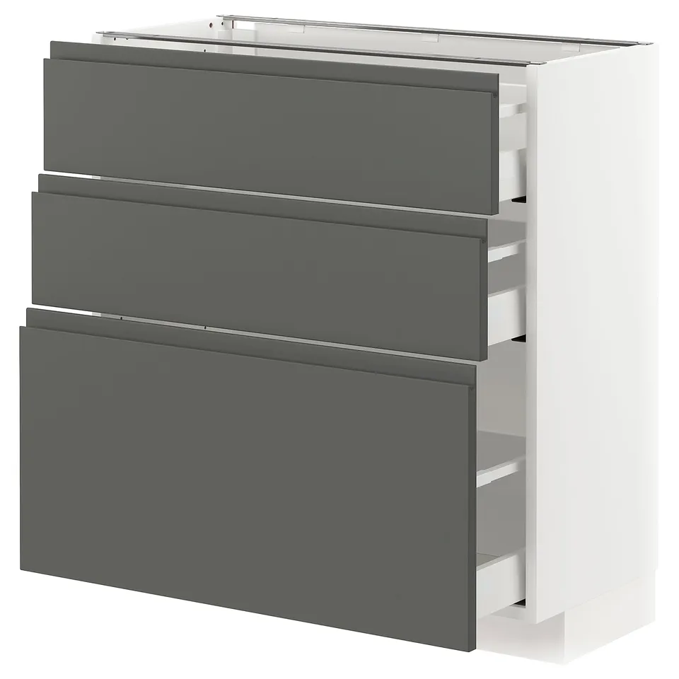 A modern white kitchen cabinet with three dark grey drawers. It has a sleek, minimalist design with integrated handles for a clean look.