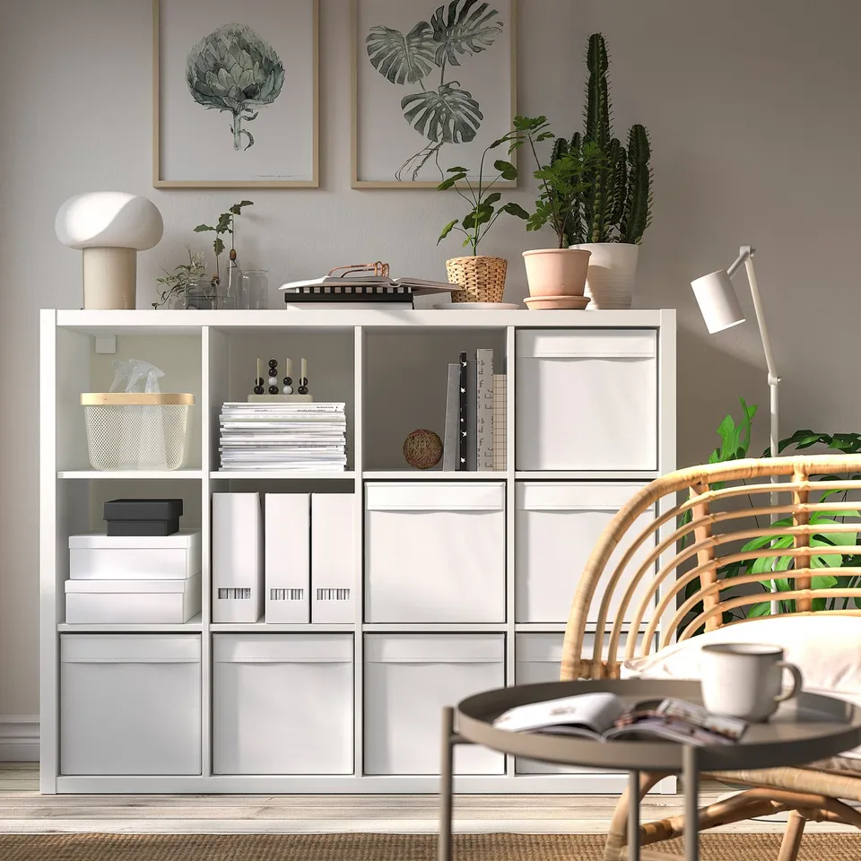 KALLAX shelving unit with books, plants, and decor. Tall, sleek, open & closed storage.
