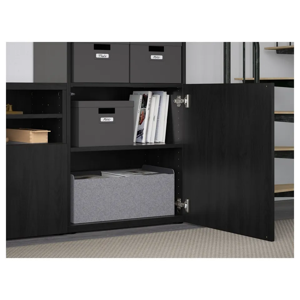 Open BESTÅ cabinet with storage boxes and shelves, soft-close hinges visible.