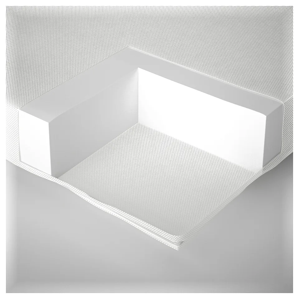 Modern white upholstered chair; sleek design with patterned fabric.