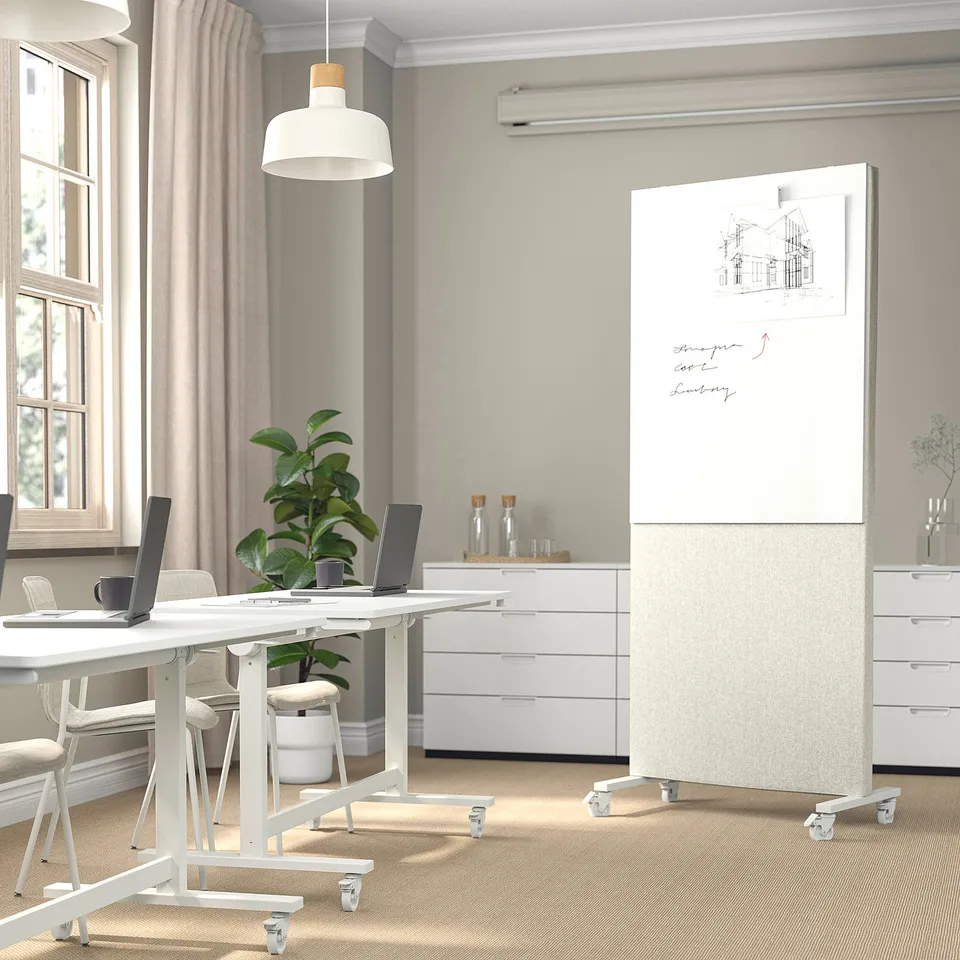 Modern minimalist office with white MITTZON screen, table, chairs, plant, and window.
