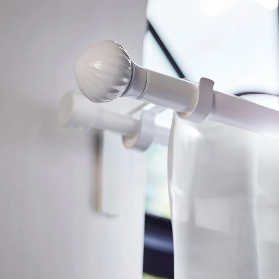 White LERBRONIA ceramic finial on curtain rod, small and round.