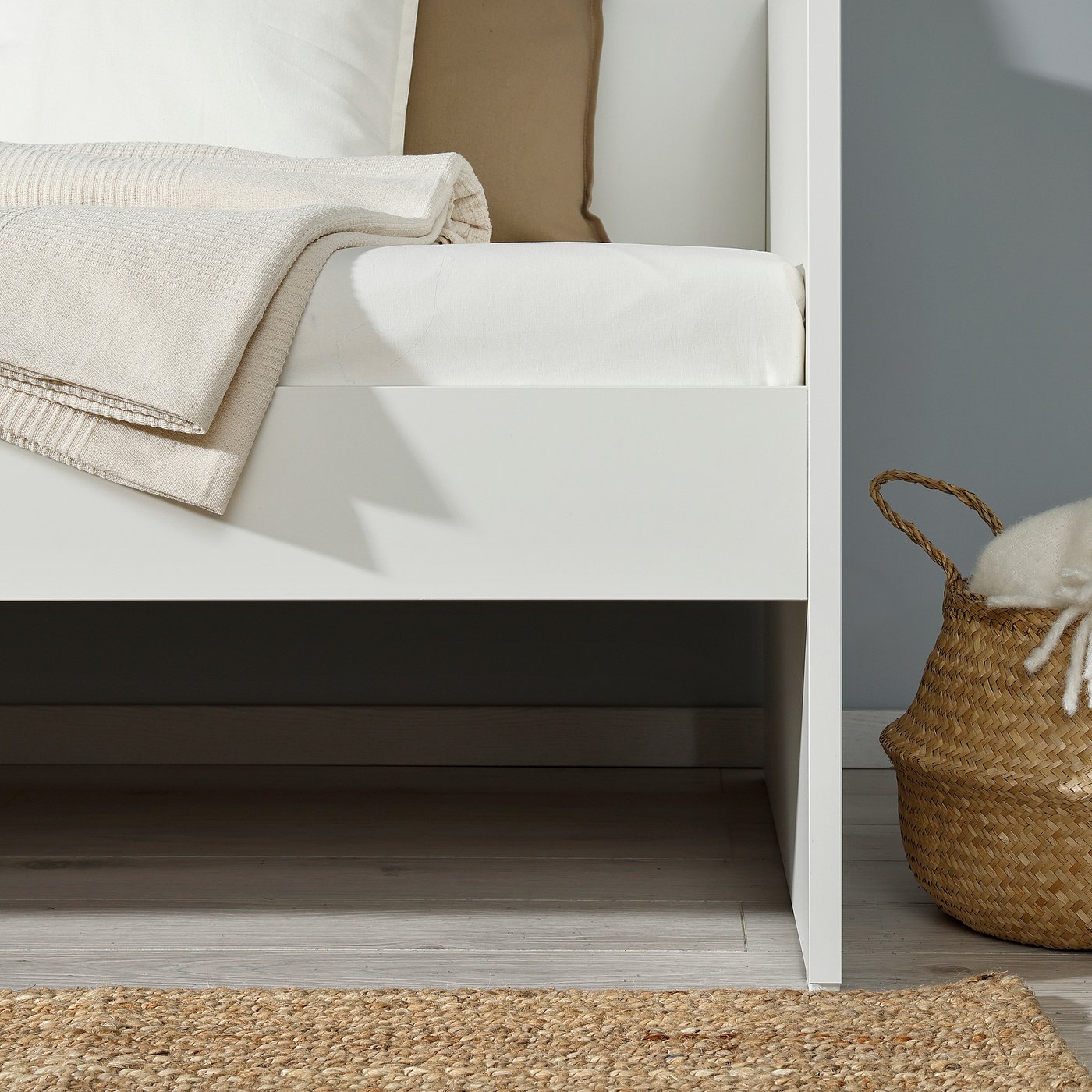 White daybed with storage and sofa functionality.