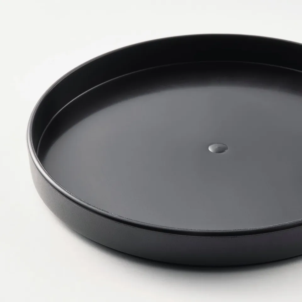 Black round plastic tray in pristine condition. High edge, smooth surface, single drainage hole. Dishwasher safe.