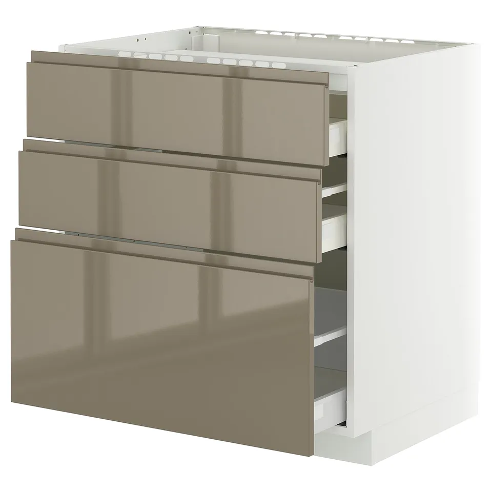 Modern kitchen cabinet, white frame with metallic bronze drawers, three drawers, sleek handles.