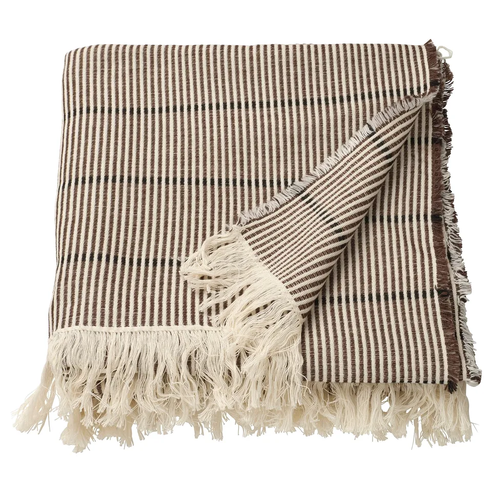 A brown and black striped cotton throw blanket with fringed edges.