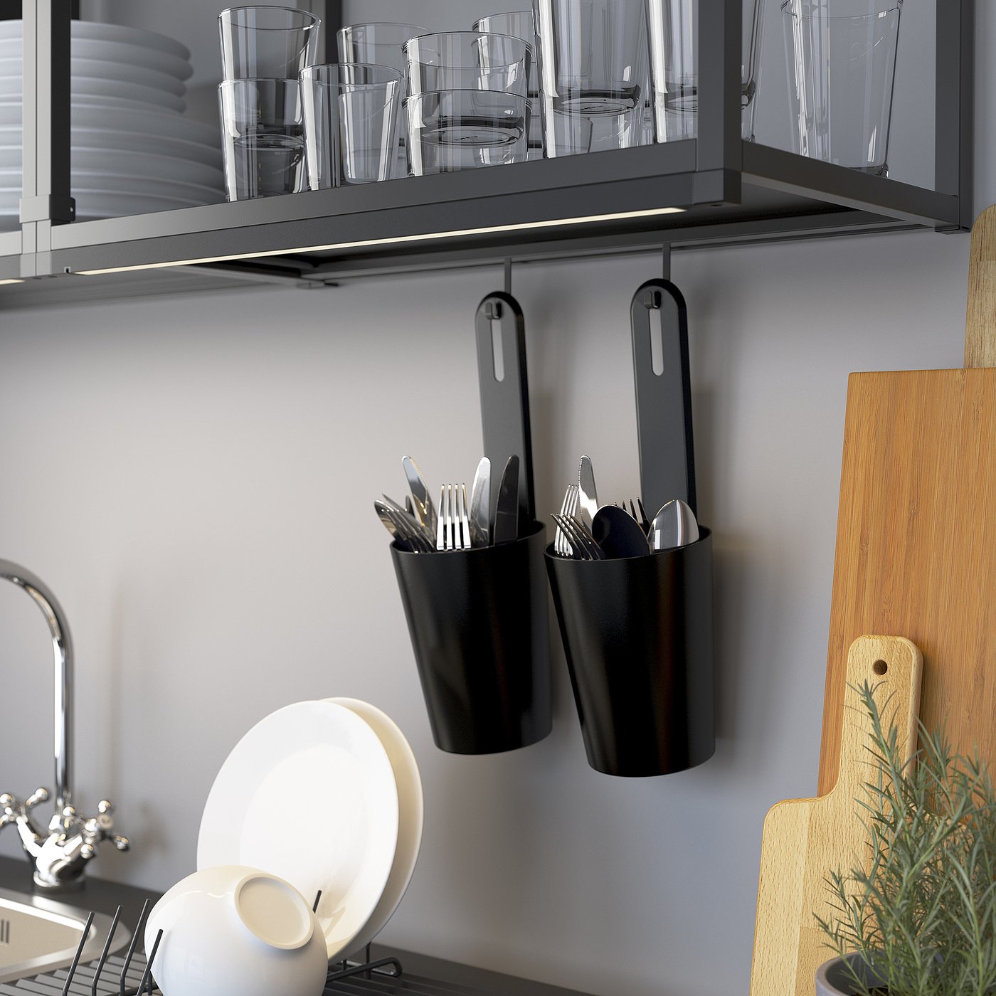 Modern kitchen shelf with hanging utensil containers and glassware.