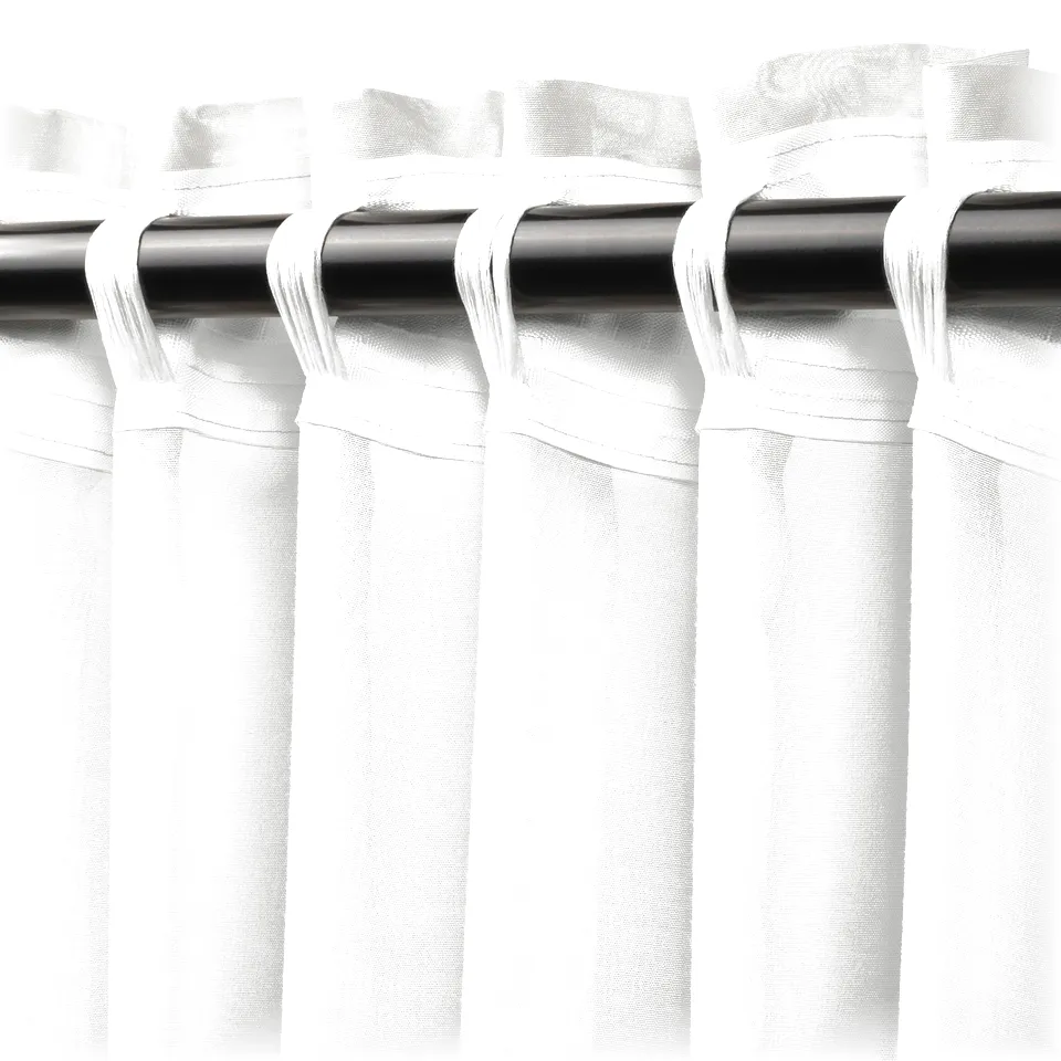 White sheer curtains hanging on rod, tied back at the top, diffusing light.