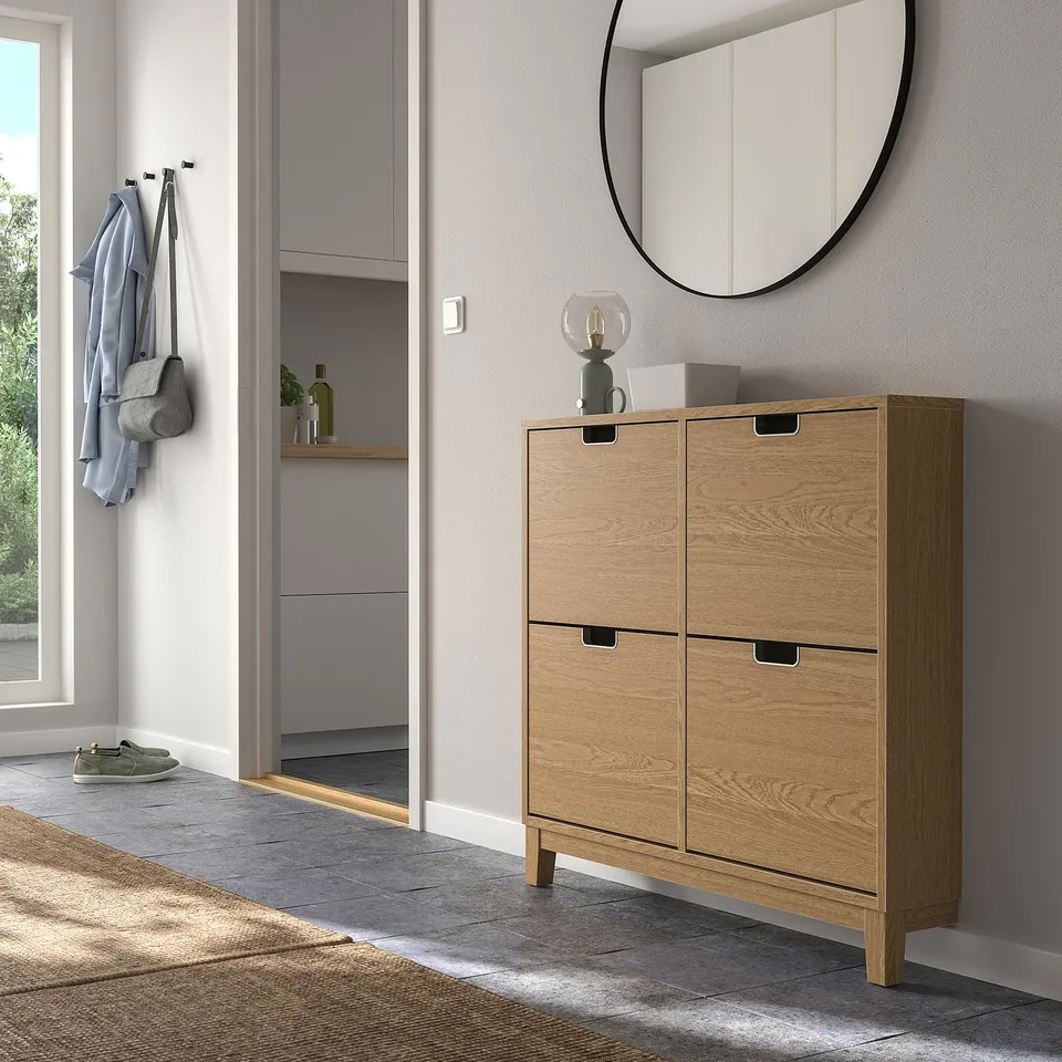 Modern entryway with STÄLL shoe cabinet, clean lines, cut-out handles, beside hooks.