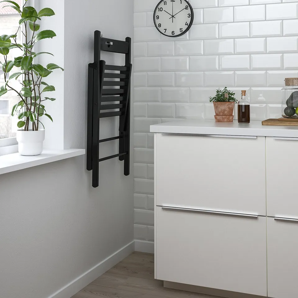 Kitchen corner with foldable wall chair, minimalist decor.