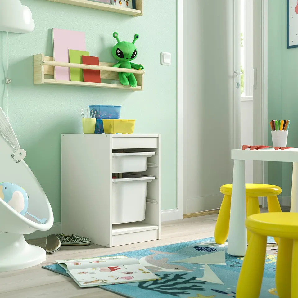 Playroom: green walls, TROFAST toy storage, yellow chair, baby swing.