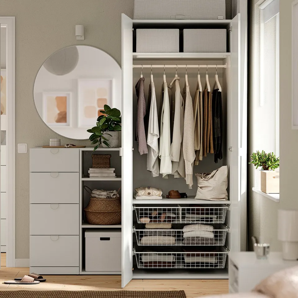 Organised closet with hanging clothes, shelves, and drawers. Adjustable, fits various spaces.