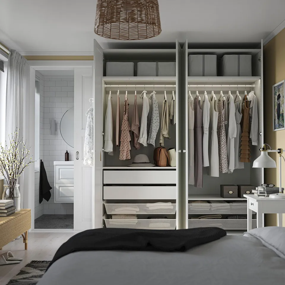 Modern bedroom with open wardrobe, soft-close doors, clothes organisers, and decor.