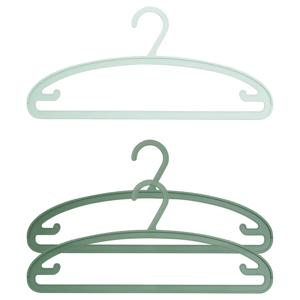 Displays two green SLIBB hangers, designed to hold clothes without leaving marks, made of 20% recycled polypropylene plastic.
