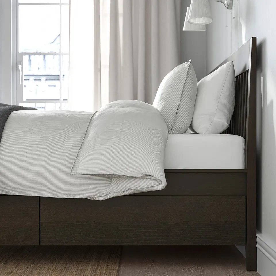 Modern bed with storage drawers, soft-close feature, wooden frame, slatted base, stylish and practical.