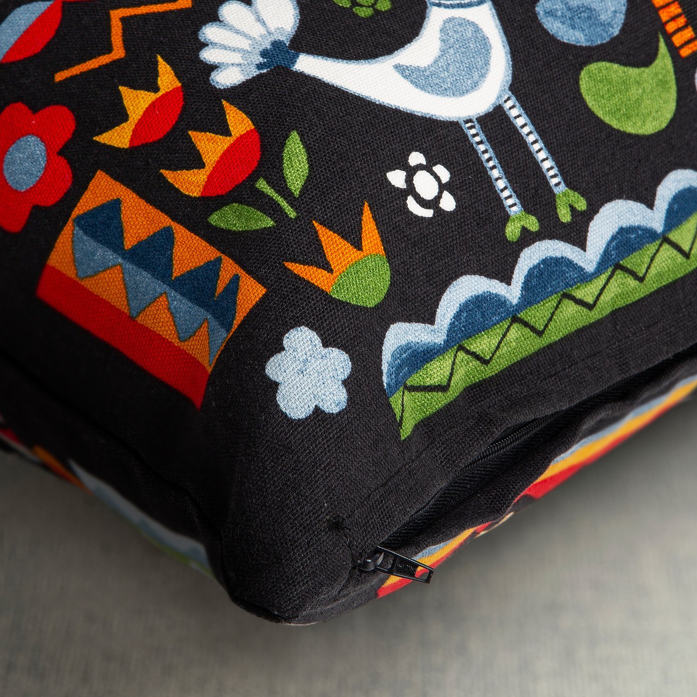 Colourful cushion with hidden zip, depicting swedish folk art.