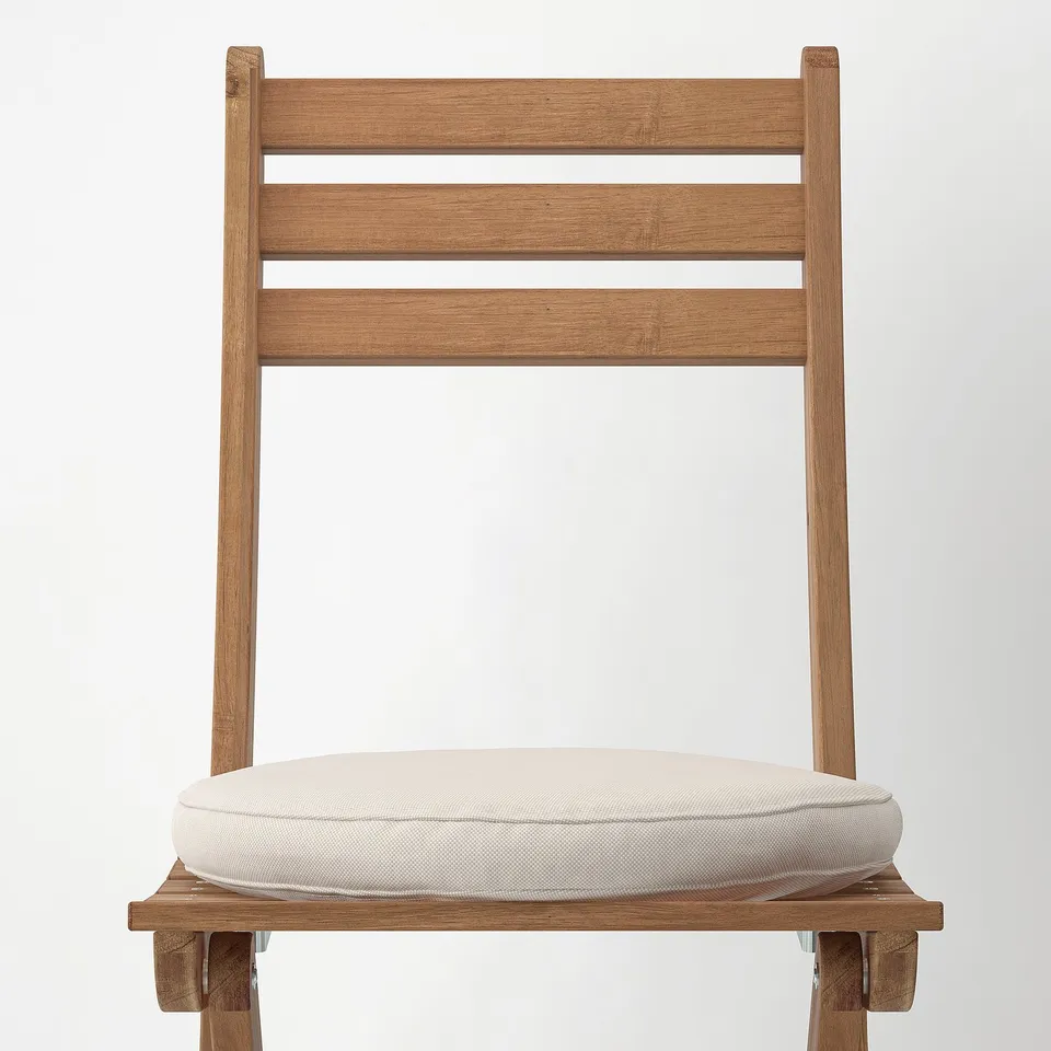 Modern wooden chair with sleek lines and plush cushion. Crafted from durable acacia, perfect for outdoors.