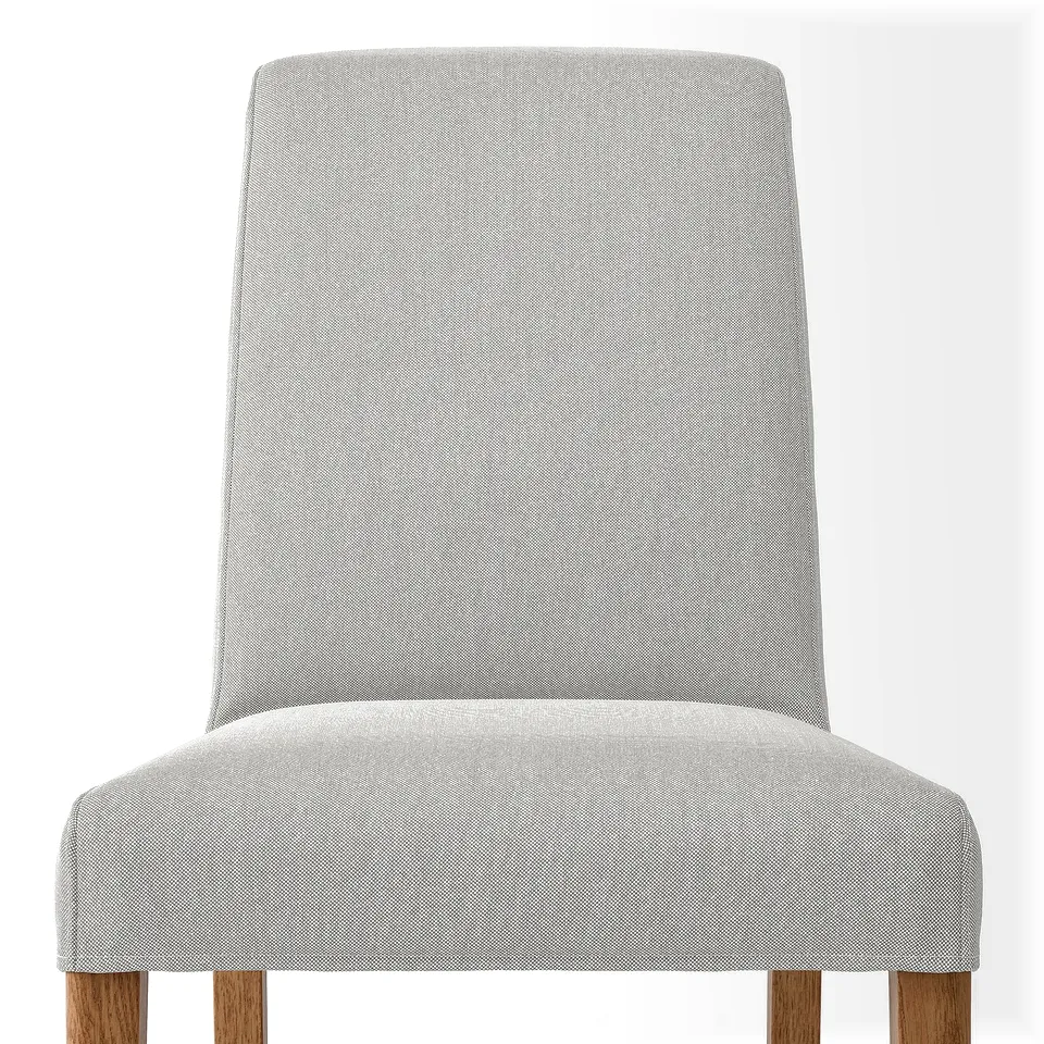 Upholstered chair w/ light grey fabric, high back, wooden legs, comfortable & durable.