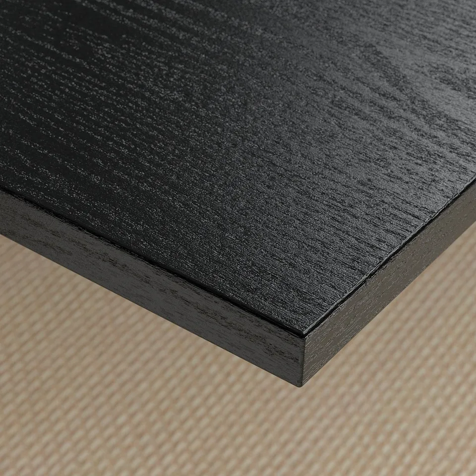 Close-up of sleek, dark wooden table surface, smooth texture, high quality finish.