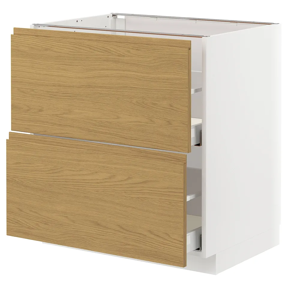 A white METOD kitchen cabinet with oak-colored drawers and a minimalist design.