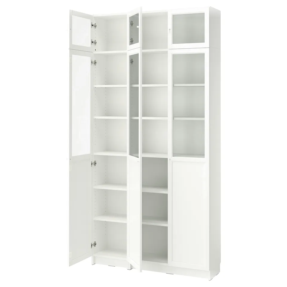A white BILLY bookcase with glass doors and adjustable shelves.