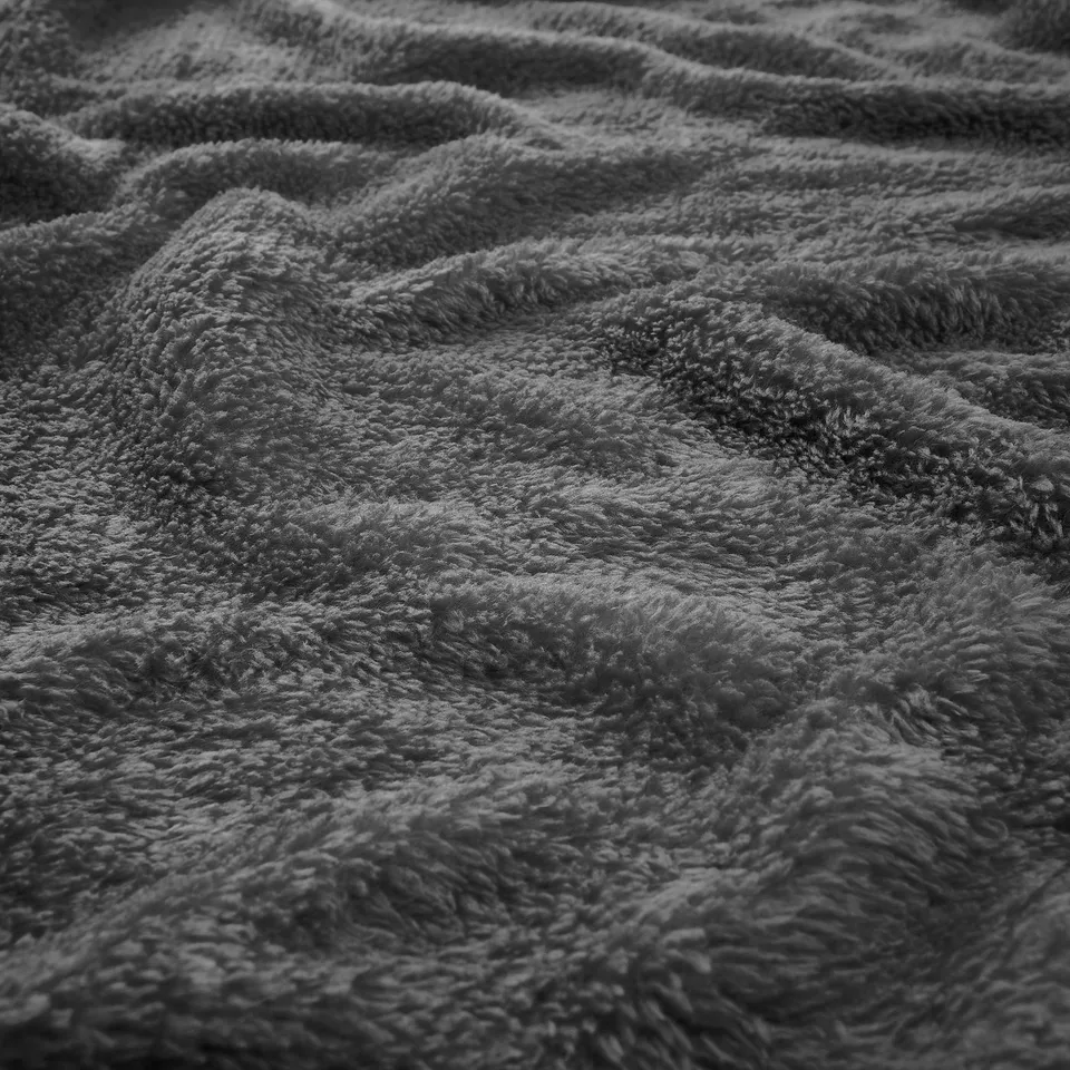 Soft fleece blanket, textured with colourful loops, invitingly plush, and warm.