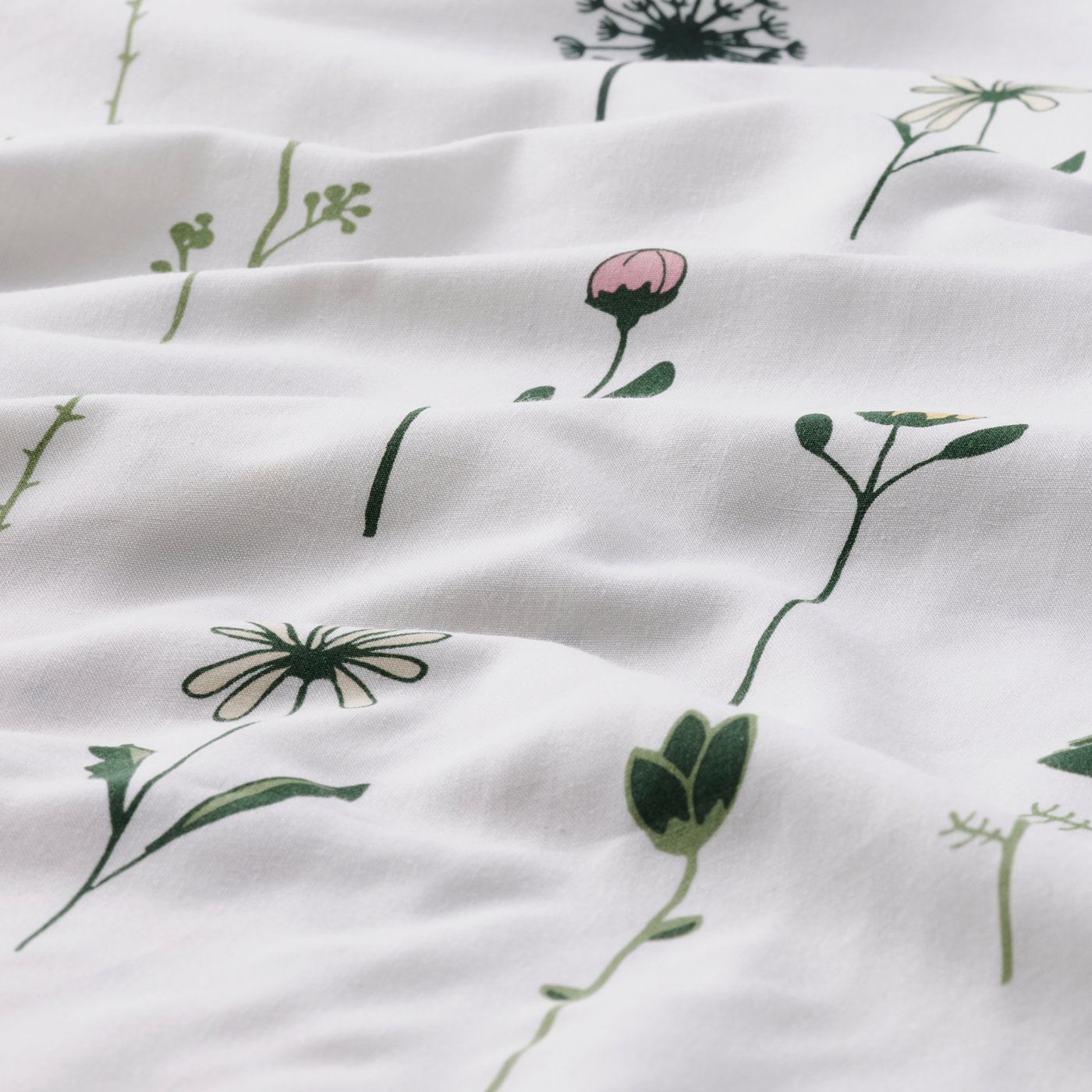 White duvet cover with delicate watercolour flowers, soft fabric texture visible.