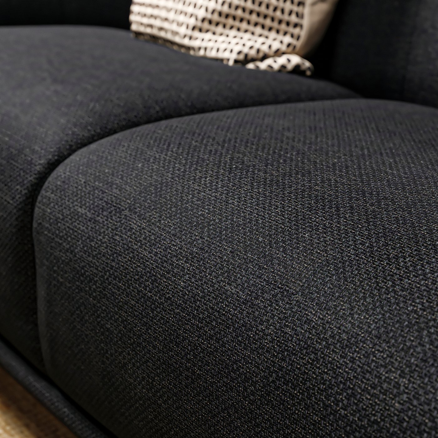 Black upholstered sofa with curved seat, deep cushions, and woven backrest. Soft, rounded shapes in modern design.