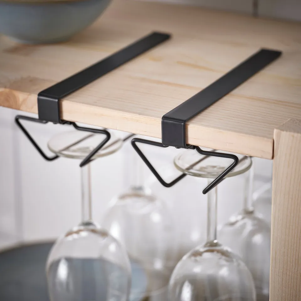 Black metal wine rack on shelf.