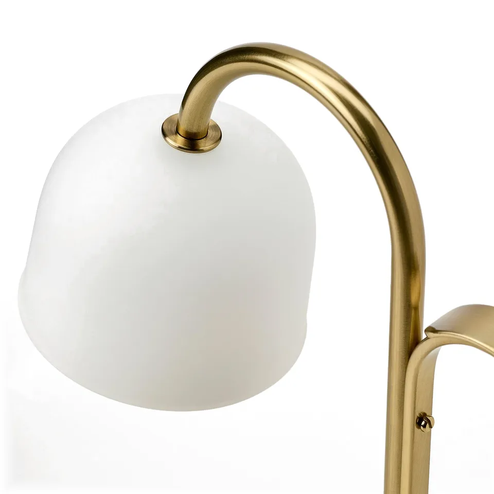 Gold-colored portable lamp with frosted glass shade; elegant design, highlighting quality and style.