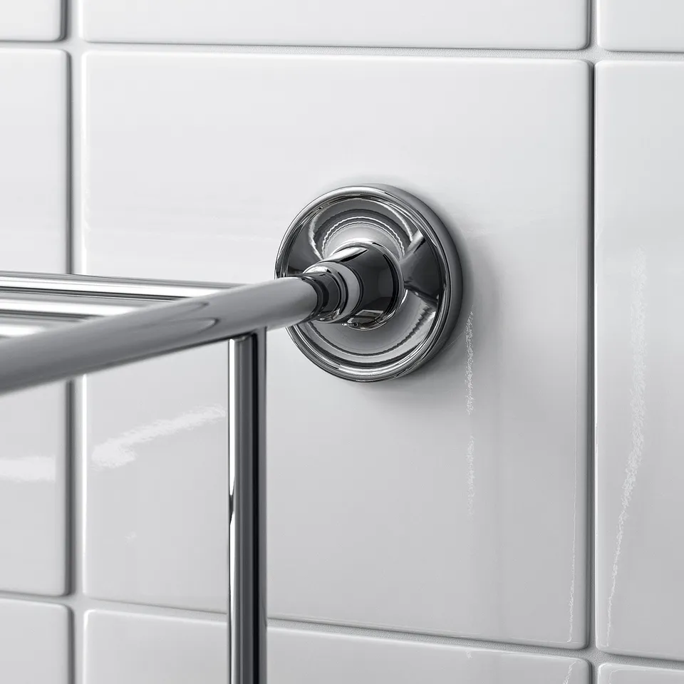 A sleek, chrome-finished towel rail mounted on a white tiled wall. The design is elegant and minimalistic.