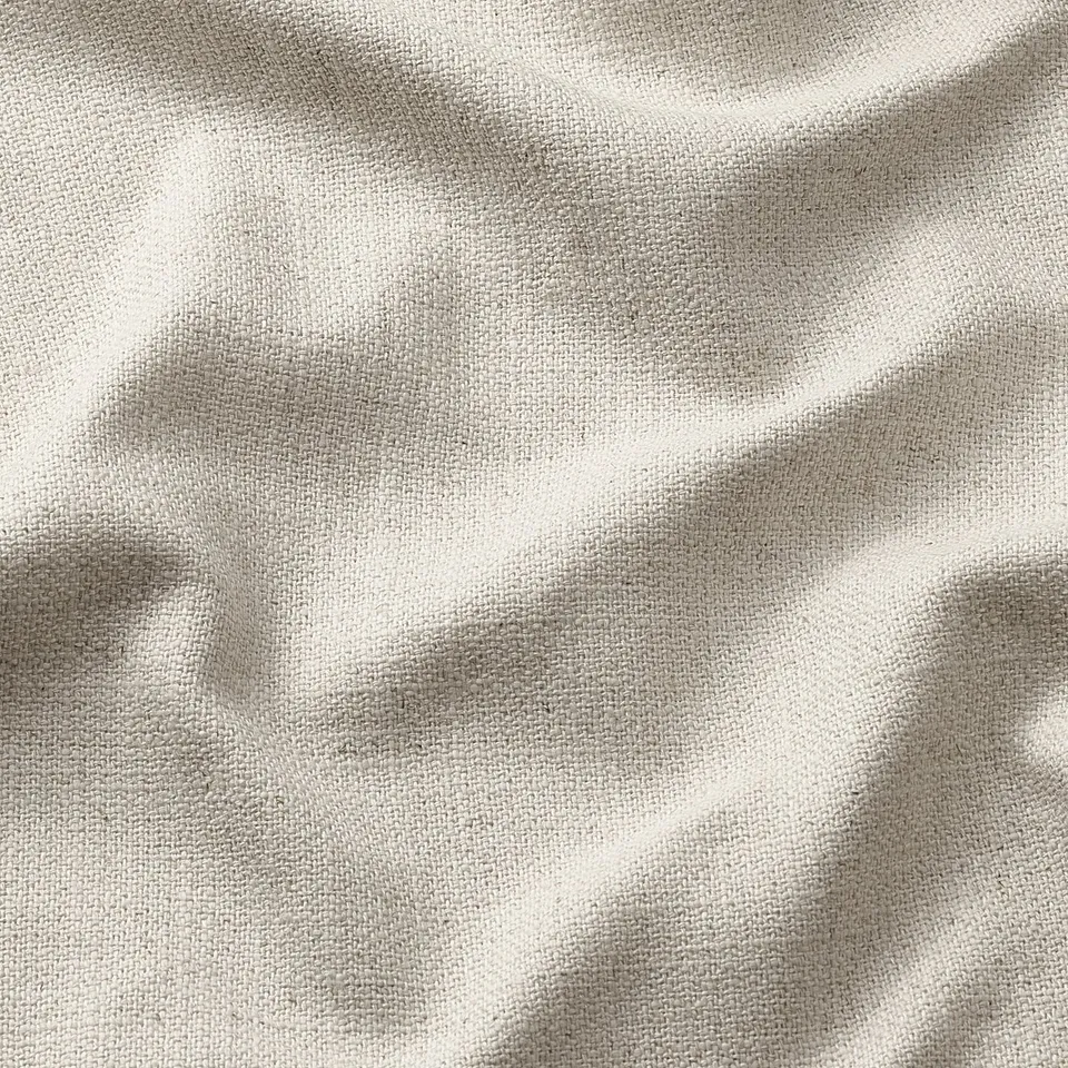 Soft, textured fabric close-up, slightly wrinkled, natural fibre look.