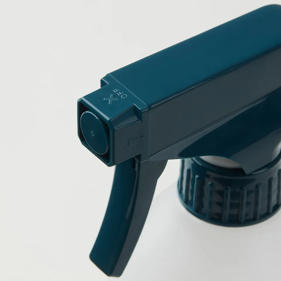 Dark blue plastic spray bottle with adjustable nozzle and locking mechanism.