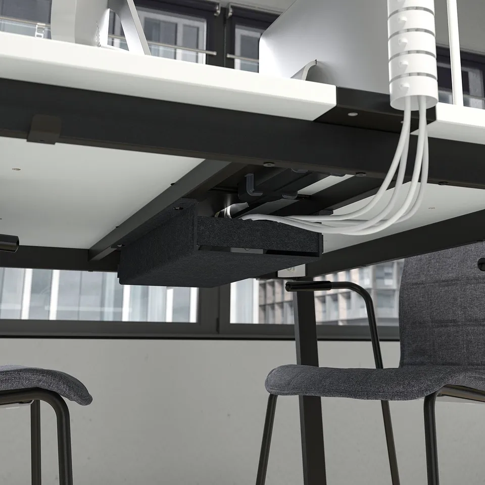 Under-desk cable management tray with power outlets.