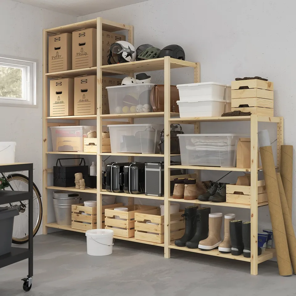 Large IVAR pine storage shelves with multiple boxes, boots, boxes, and bike.