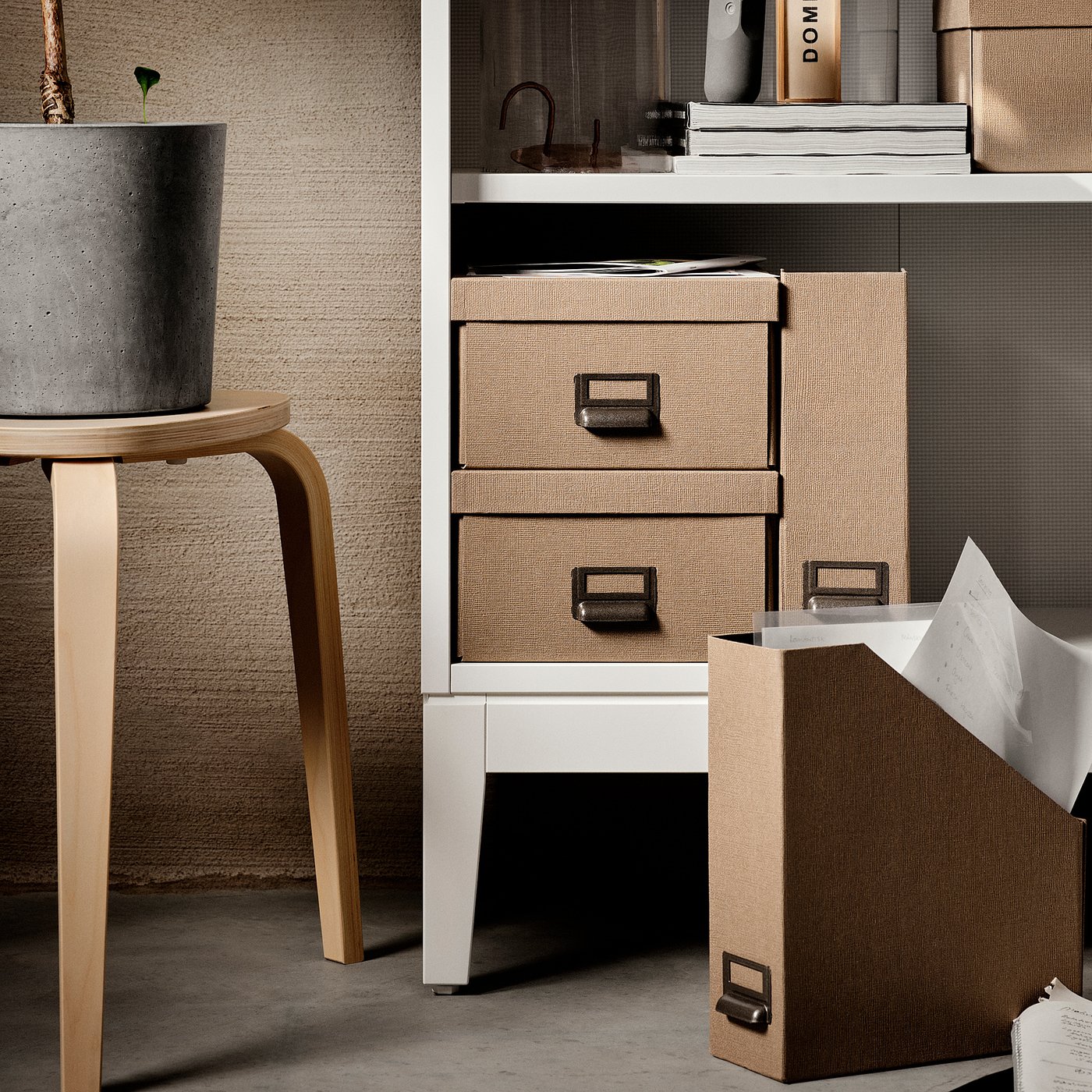 Modern storage unit, IDANÄS series. White shelves with woven beige drawers. Curtains, books, and stool shown.