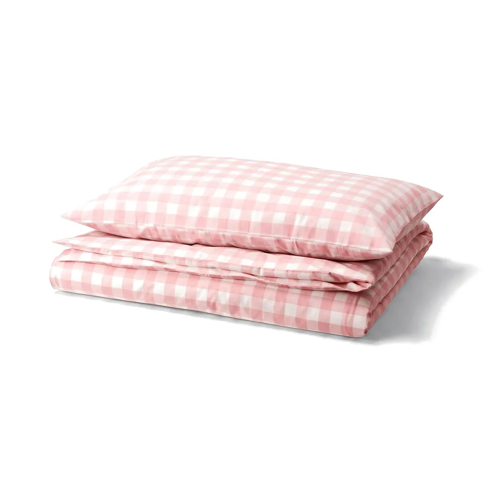A neatly folded pink and white gingham check duvet cover set.
