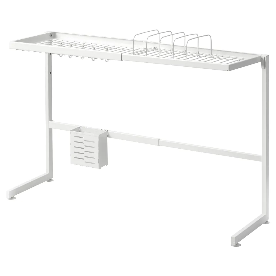 A white SKYGGFISK dish rack with multiple compartments, hooks, and a cutlery section. It sits over sinks, draining dishes efficiently.
